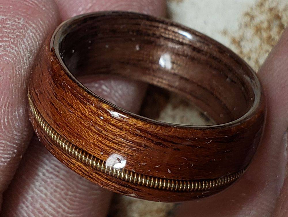 Sapele on Walnut with a Brass Guitar String Inlay
